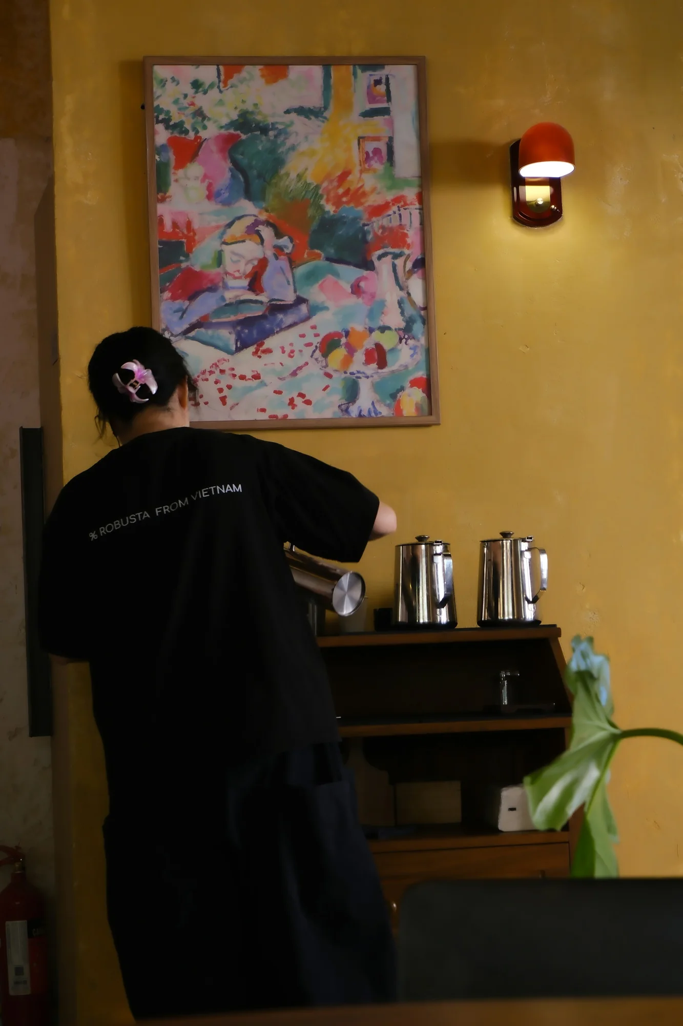 Barista preparing coffee behind a counter